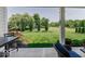 Covered patio offers a peaceful view of the large yard with mature trees and landscaping at 15879 Viking Commander Way, Westfield, IN 46074