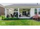 Inviting covered patio with outdoor seating and well-maintained landscaping at 15879 Viking Commander Way, Westfield, IN 46074