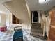 View of the basement featuring checkerboard flooring, stairs to the upper level, and dehumidifying equipment at 1749 N Graham Ave, Indianapolis, IN 46218