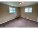 Bedroom showcasing neutral walls, carpeted floors, and two windows for natural light at 1749 N Graham Ave, Indianapolis, IN 46218