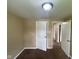 Simple bedroom featuring neutral walls, carpeted flooring, and doors to adjacent rooms at 1749 N Graham Ave, Indianapolis, IN 46218