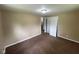 Bedroom featuring neutral walls, carpeted flooring, closet doors, and access to other rooms at 1749 N Graham Ave, Indianapolis, IN 46218
