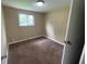 Bedroom showcasing neutral walls, carpeted flooring, and a window for natural light at 1749 N Graham Ave, Indianapolis, IN 46218