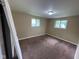 View of bedroom with two windows allowing natural light and carpeted floor at 1749 N Graham Ave, Indianapolis, IN 46218