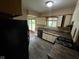 Kitchen featuring wooden cabinets, laminate countertops and a view of the yard at 1749 N Graham Ave, Indianapolis, IN 46218