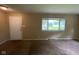 Cozy living room featuring neutral paint, carpeted floors, and ample natural light from a large window at 1749 N Graham Ave, Indianapolis, IN 46218