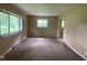 View of living room with multiple windows providing plenty of natural light and neutral carpeting at 1749 N Graham Ave, Indianapolis, IN 46218