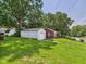 Backyard of house features a well-manicured lawn and a detached garage at 220 Central Ave, Anderson, IN 46012