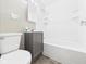 Full bathroom featuring gray vanity with integrated sink and shower/tub combo at 220 Central Ave, Anderson, IN 46012