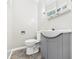 Well-lit bathroom features a gray vanity and a large mirror above the sink at 220 Central Ave, Anderson, IN 46012