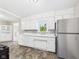 Spacious kitchen featuring plenty of white cabinets and a stainless-steel refrigerator at 220 Central Ave, Anderson, IN 46012