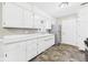 Kitchen with white cabinets, neutral walls, and stainless-steel refrigerator at 220 Central Ave, Anderson, IN 46012