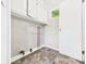 Well-lit laundry area features washer hookups and storage cabinet space at 220 Central Ave, Anderson, IN 46012