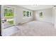 Bright living room featuring neutral carpet and large windows for natural light at 220 Central Ave, Anderson, IN 46012