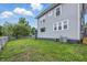 A spacious green backyard features a well-maintained lawn, siding, and bright windows at 2896 Sutherland Ave, Indianapolis, IN 46205