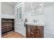 Charming bathroom with a pedestal sink, tiled walls and floors, plus a glass paned door at 2896 Sutherland Ave, Indianapolis, IN 46205