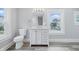 Bright bathroom with modern white vanity, toilet, sink, and view to the exterior at 2896 Sutherland Ave, Indianapolis, IN 46205