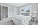 Bright bedroom featuring carpet floors and a comfortable bed near two big windows at 2896 Sutherland Ave, Indianapolis, IN 46205