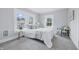 Well-lit bedroom featuring three large windows, carpet floors, and a comfortable bed at 2896 Sutherland Ave, Indianapolis, IN 46205
