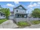 Charming two-story home with blue and gray siding, attached garage, and a lovely front yard at 2896 Sutherland Ave, Indianapolis, IN 46205