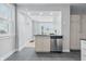 Modern kitchen with stainless steel dishwasher and view into dining area at 2896 Sutherland Ave, Indianapolis, IN 46205