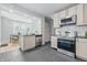 Modern kitchen features stainless steel appliances, light wood cabinets, and tiled backsplash at 2896 Sutherland Ave, Indianapolis, IN 46205