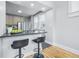 Eat-in kitchen features barstool seating, a modern faucet, and stainless appliances at 2896 Sutherland Ave, Indianapolis, IN 46205