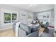 Bright and airy living room with hardwood floors, modern furnishings, and abundant natural light at 2896 Sutherland Ave, Indianapolis, IN 46205