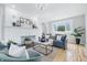 Open-concept living room with a white brick fireplace, a plush gray sofa, and stylish decor at 2896 Sutherland Ave, Indianapolis, IN 46205