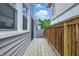 Exterior side yard featuring a wooden walkway between two buildings, leading to the backyard at 2896 Sutherland Ave, Indianapolis, IN 46205