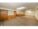 Finished basement featuring carpet and wood paneling at 2908 Sherman St, Anderson, IN 46016