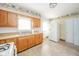 Kitchen featuring wood cabinets, dual stainless steel sink, and white appliances at 2908 Sherman St, Anderson, IN 46016