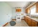 Kitchen featuring linoleum flooring, oak cabinets, and white appliances at 2908 Sherman St, Anderson, IN 46016