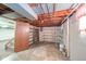 Basement storage room with exposed ceiling and shelving at 2908 Sherman St, Anderson, IN 46016