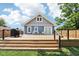 Spacious wooden backyard deck featuring a grill, seating, and stylish cable railing at 2928 Mounds Rd, Anderson, IN 46016