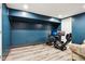 Finished basement with dark blue walls and an upgraded gaming setup with three monitors at 2928 Mounds Rd, Anderson, IN 46016