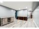 A finished basement area with light colored wood-grain floors and a decorative accent wall at 2928 Mounds Rd, Anderson, IN 46016