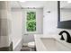 Bright bathroom with a shower/tub combo and a sink with white countertops and bronze hardware at 2928 Mounds Rd, Anderson, IN 46016