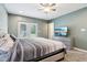 Comfortable bedroom with a ceiling fan, gray walls, and french doors to the exterior at 2928 Mounds Rd, Anderson, IN 46016