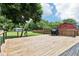 Wooden deck with modern cable railings, ideal for outdoor dining and enjoying the surrounding greenery and spacious backyard at 2928 Mounds Rd, Anderson, IN 46016
