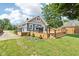 Spacious wooden deck with modern railings and ample space for entertaining, surrounded by a well-maintained lawn and landscaping at 2928 Mounds Rd, Anderson, IN 46016