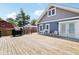 Expansive wooden deck is equipped with a grill and outdoor seating, perfect for enjoying outdoor cooking and relaxation at 2928 Mounds Rd, Anderson, IN 46016