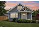 Charming home showcasing architectural details, fresh landscaping, and inviting front porch at 2928 Mounds Rd, Anderson, IN 46016
