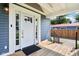 Inviting entryway featuring a white front door with glass panels and a cozy wooden porch at 2928 Mounds Rd, Anderson, IN 46016
