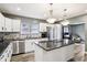 Modern kitchen with stainless steel appliances, an island, and sleek countertops at 2928 Mounds Rd, Anderson, IN 46016