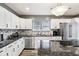 Bright kitchen featuring white cabinetry, stainless steel appliances, and granite countertops at 2928 Mounds Rd, Anderson, IN 46016