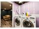 Laundry room with new washer and dryer units, open to a finished living space at 2928 Mounds Rd, Anderson, IN 46016