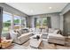 Bright living room features large windows, a comfortable sectional sofa, and neutral decor at 2928 Mounds Rd, Anderson, IN 46016