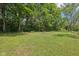 Expansive, well-manicured backyard featuring mature trees and open space, offering privacy and a serene outdoor environment at 2928 Mounds Rd, Anderson, IN 46016