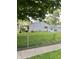 Exterior shot of a home with a cozy covered porch, fenced yard, and a detached garage at 3101 Danbury Rd, Indianapolis, IN 46222